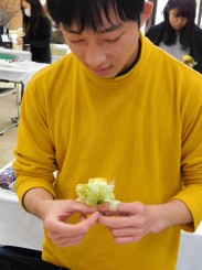 卒業生の胸に着けるコサージュを制作する学生