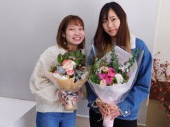 制作した花束を持つ学生二人